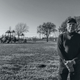 John Beard poses at Carver Terrace Park in Port Arthur, with refinery smokestacks visible less than half a mile away.
